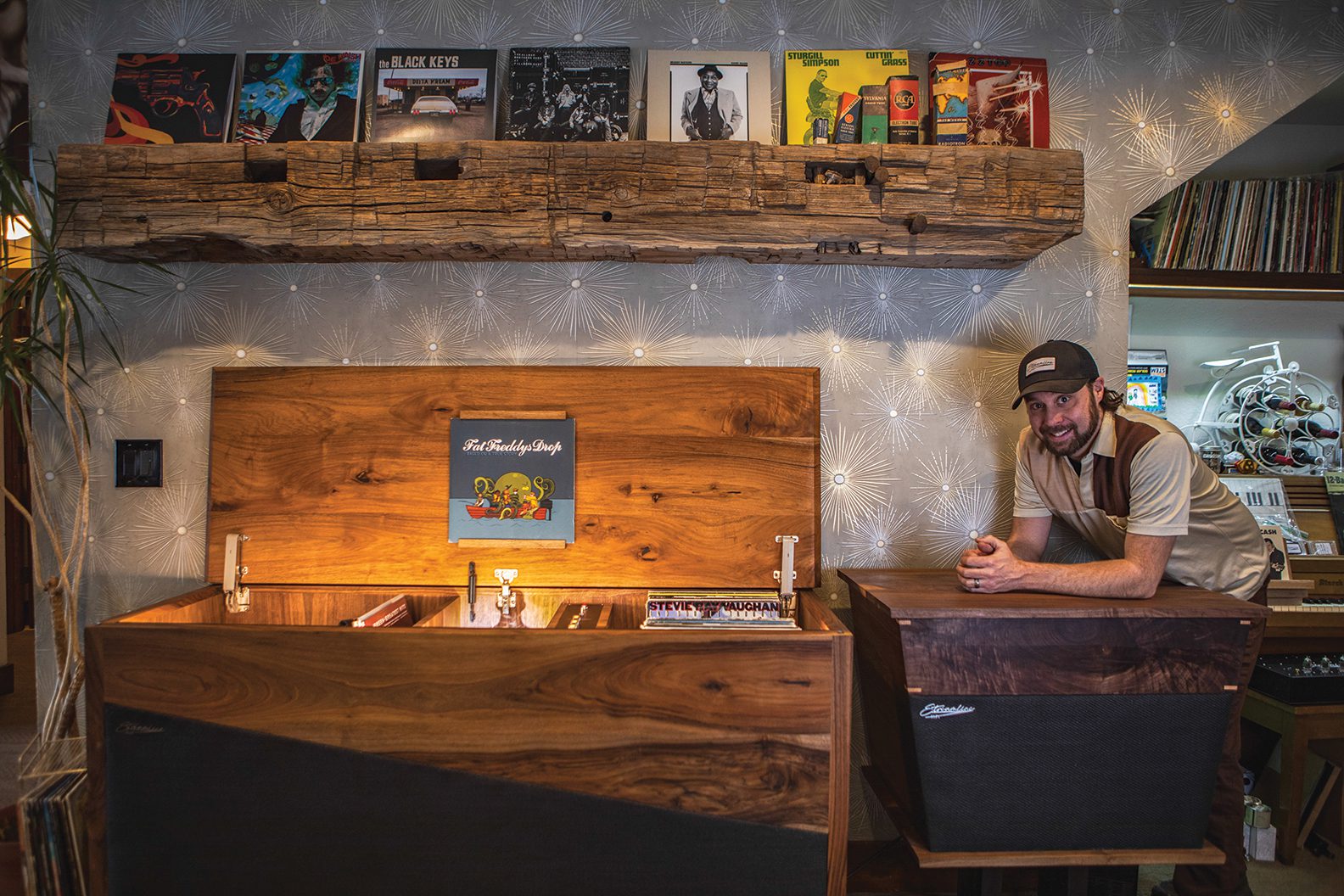 Steve Morris, owner of Streamline HiFi with two consoles.